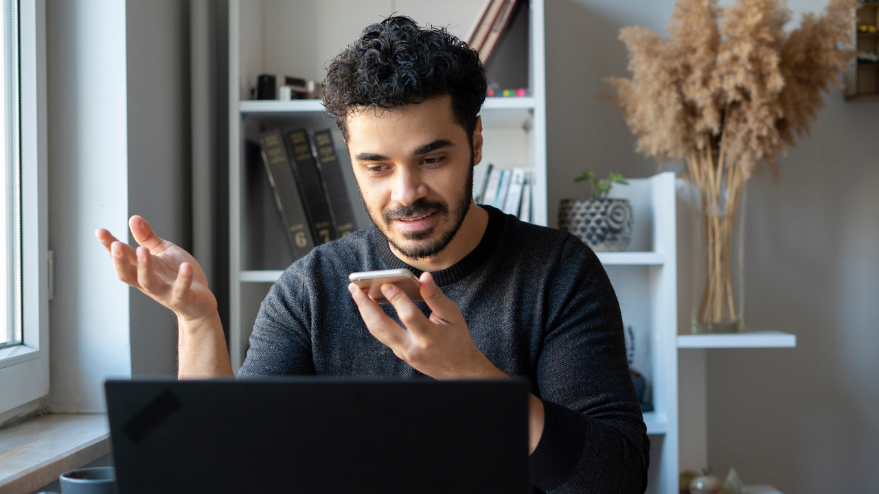 Person recording audio content at their desk for team distribution