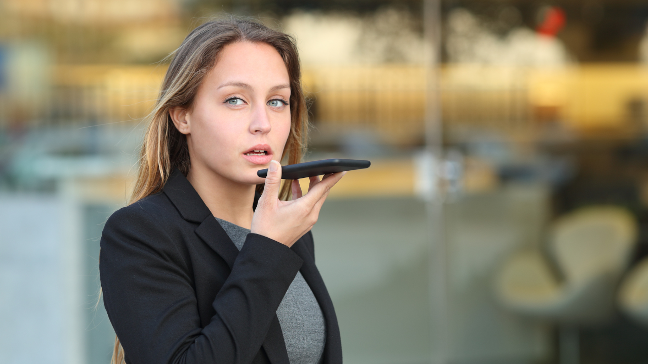 Professional in business attire looking thoughtfully at their phone