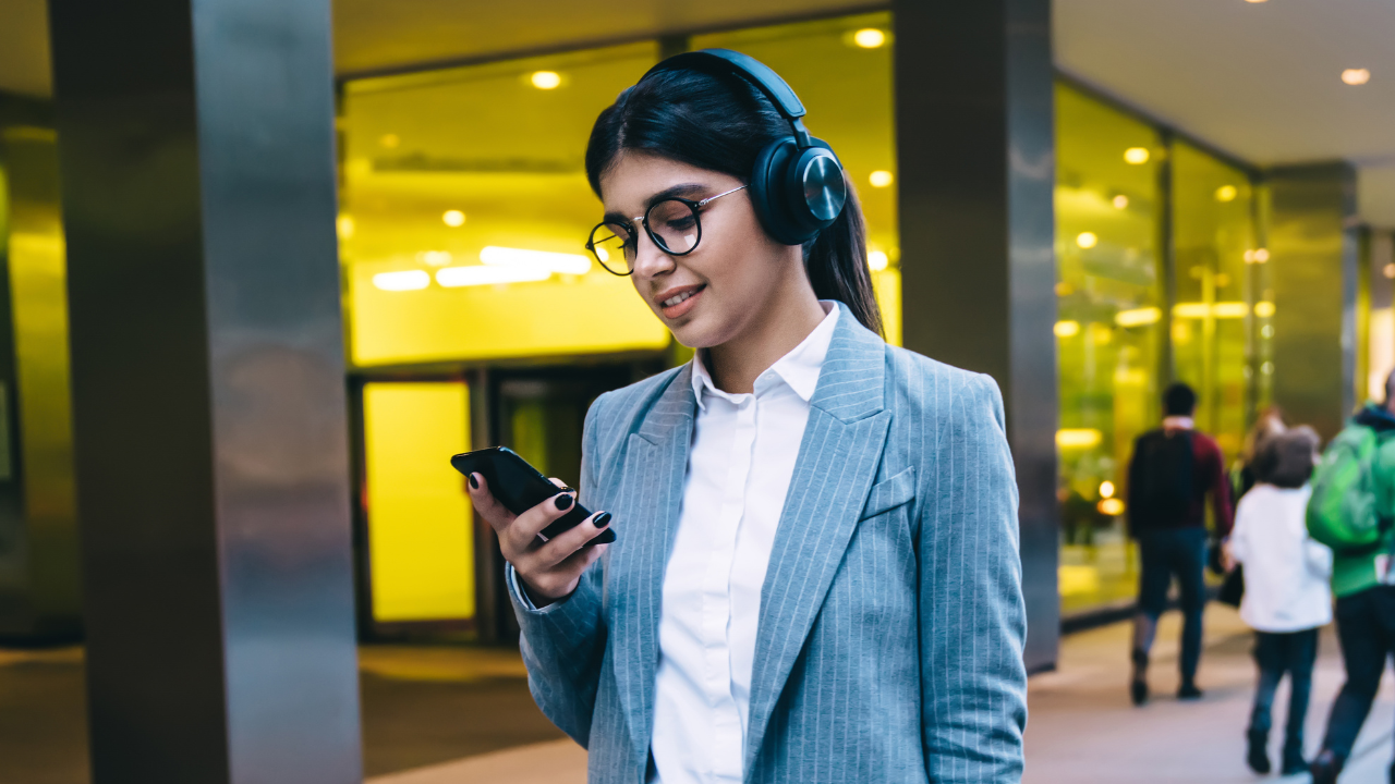 Executive walking outside while using smartphone, suggesting flexible communication