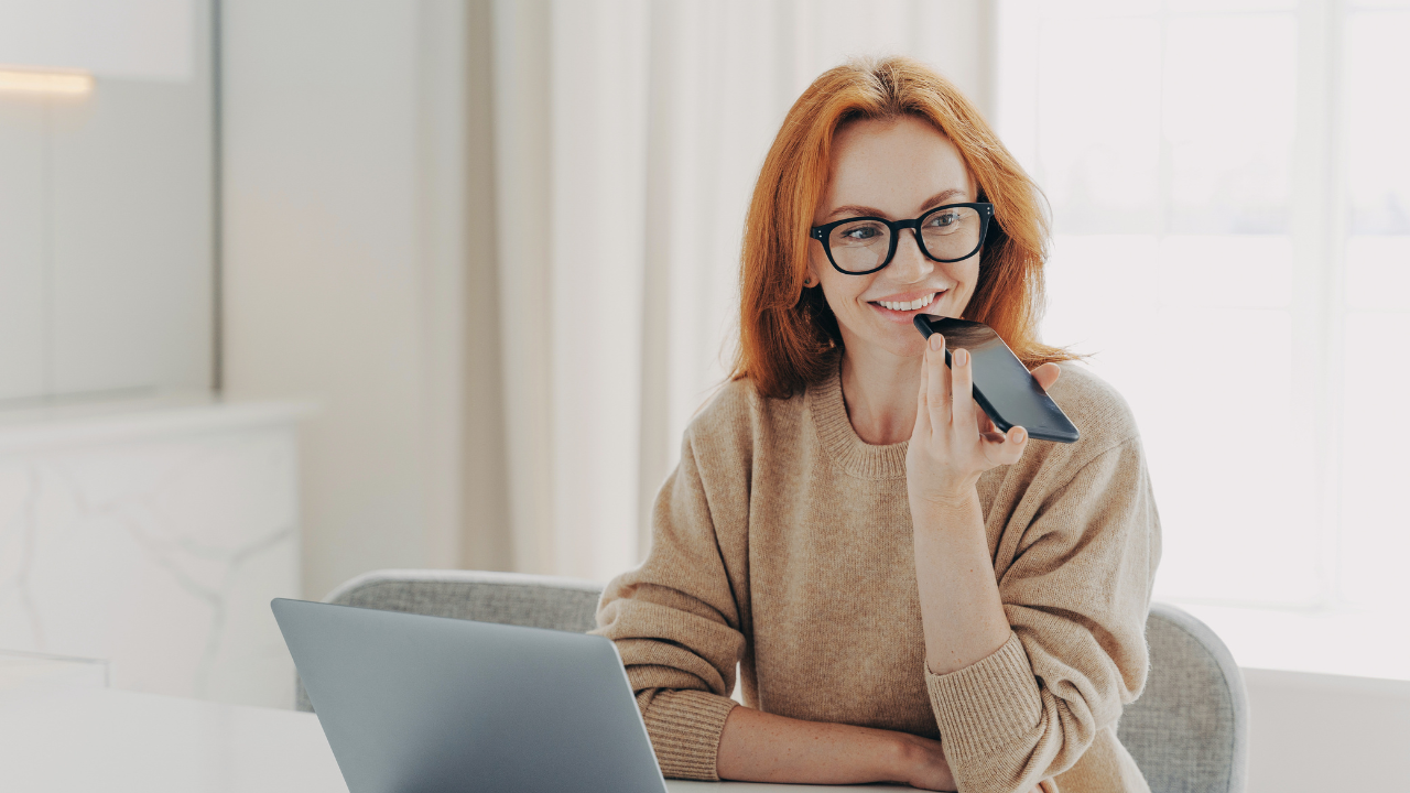 Life coach recording a voice message for a client